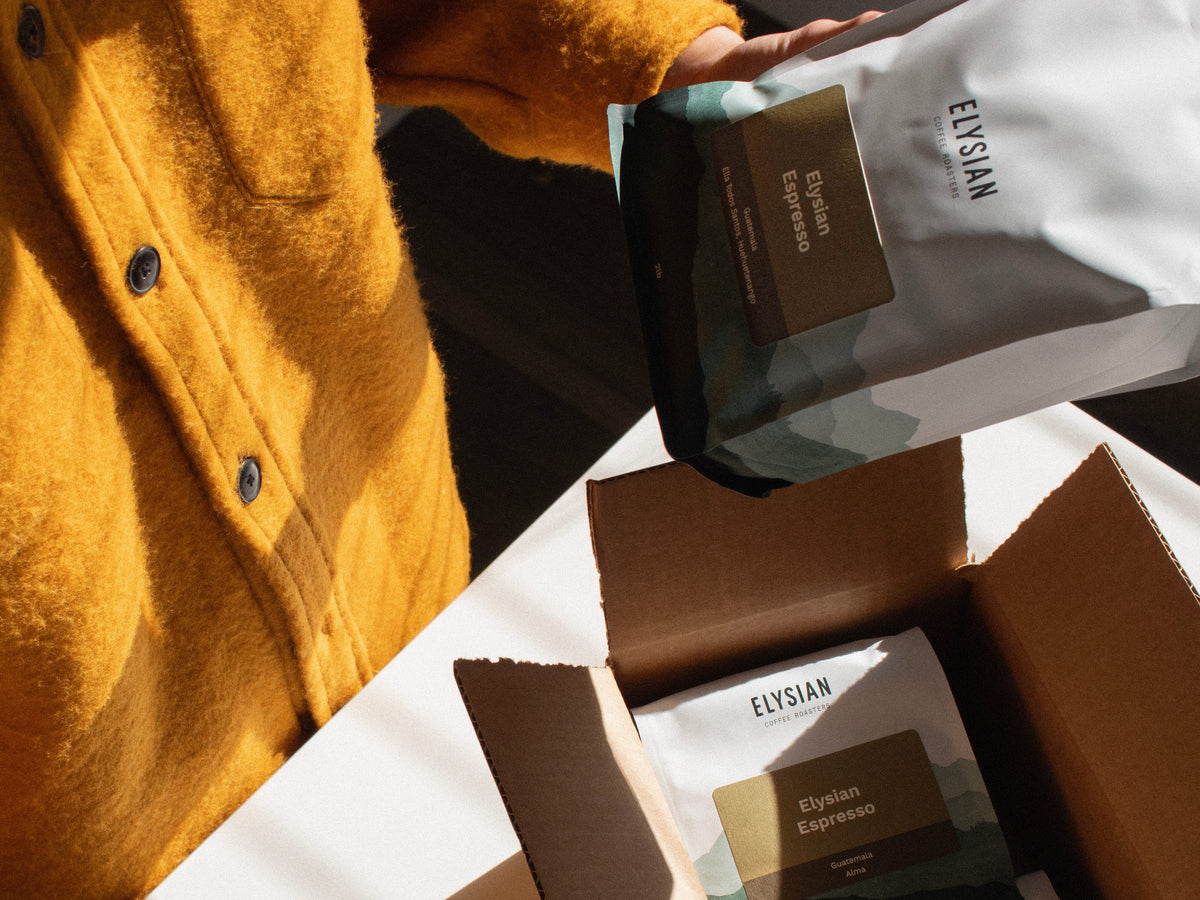 Unboxing bags of Elysian Espresso from a shipping box